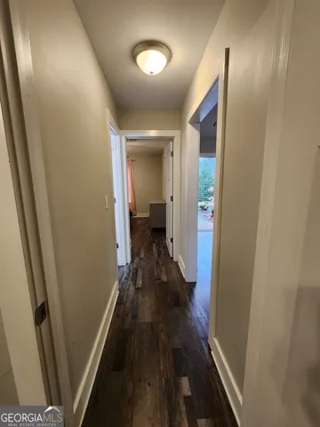 a view of a hallway and wooden floor