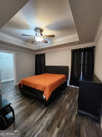 a bed sitting in a bedroom next to a window