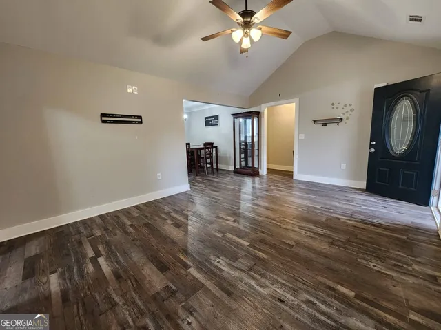 wooden floor in an empty room with a window
