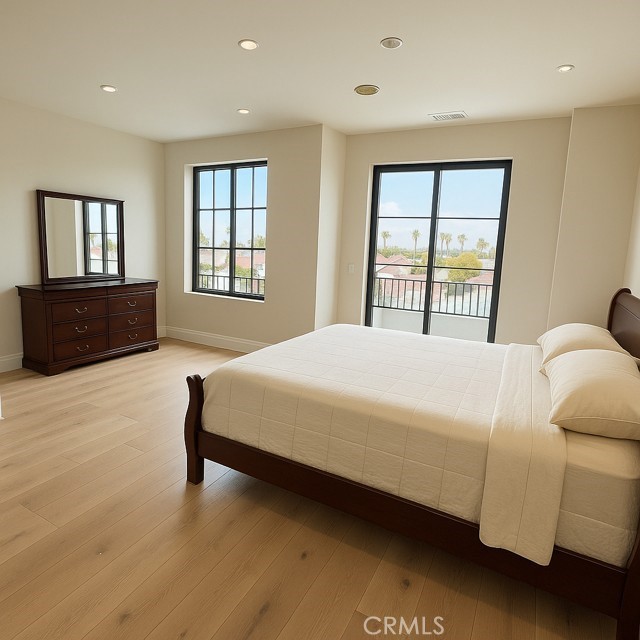 145 West Canada San Clemente, CA 92672 - Photo 2 of 7 a spacious bedroom with a bed and wooden floor