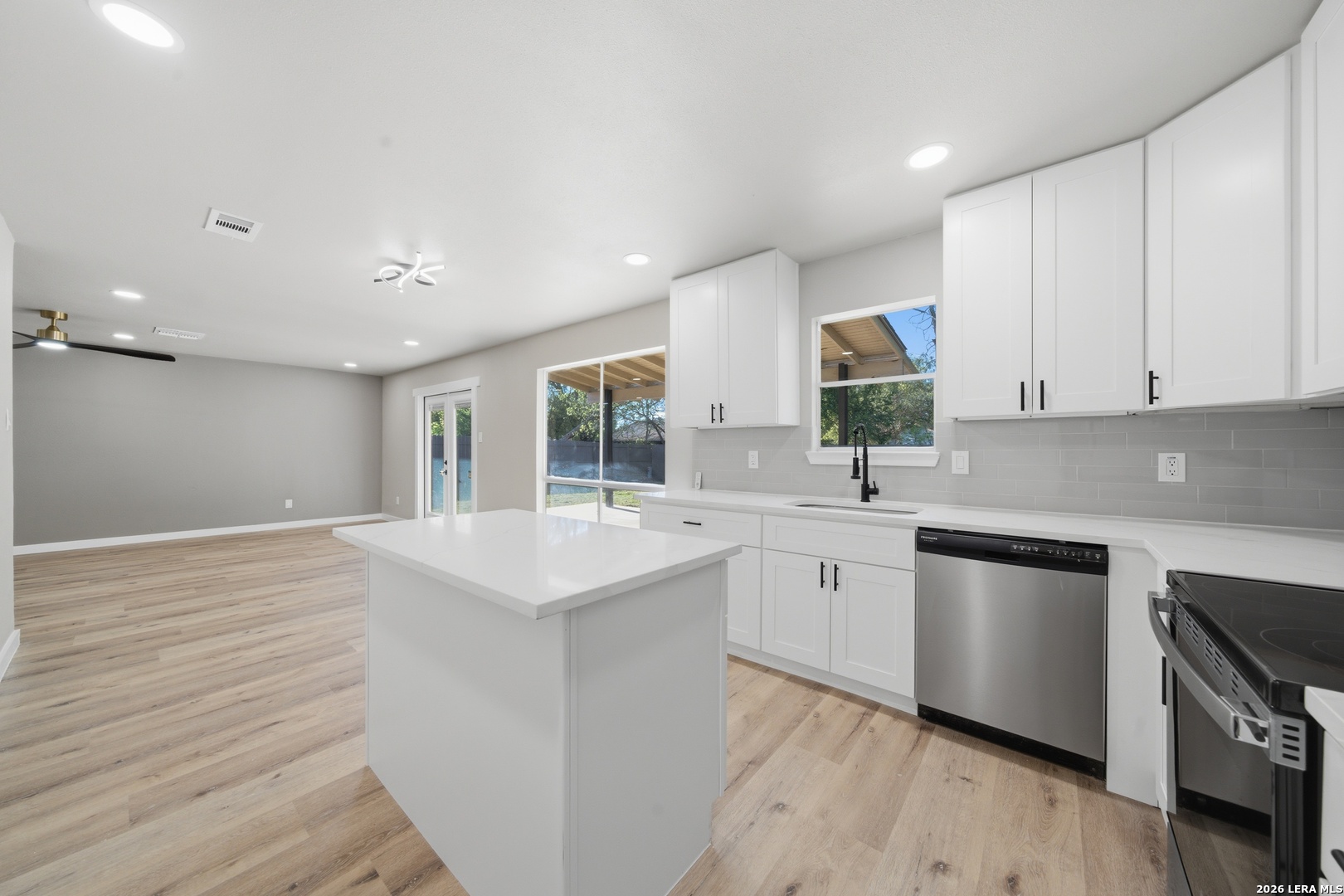 9446 Cliff Way Street San Antonio, TX 78250 - Photo 11 of 24 a kitchen with white cabinets appliances and sink