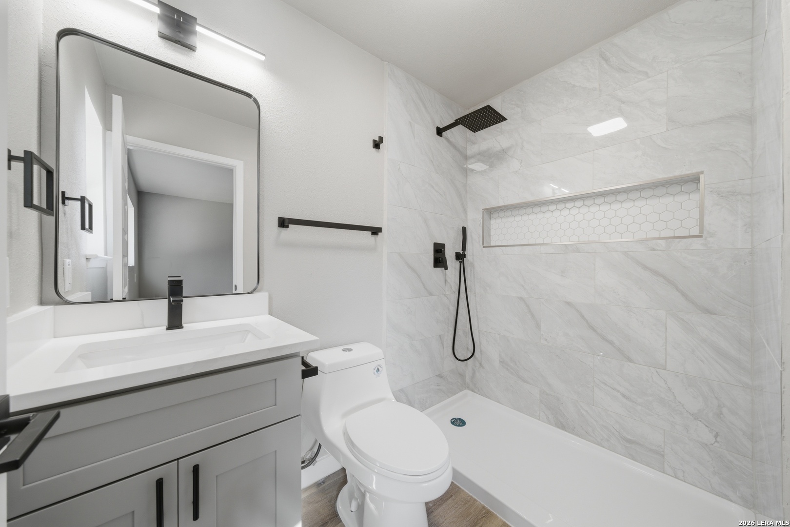 9446 Cliff Way Street San Antonio, TX 78250 - Photo 17 of 24 a bathroom with a sink toilet and shower
