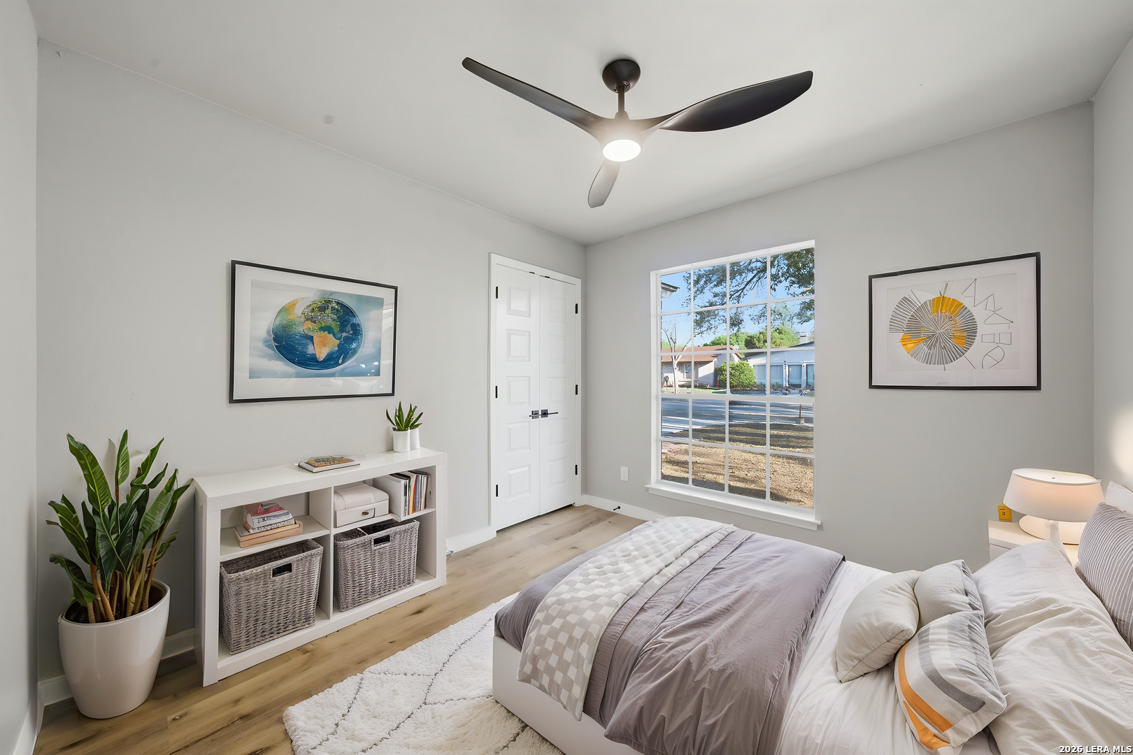 9446 Cliff Way Street San Antonio, TX 78250 - Photo 19 of 24 a bedroom with a large bed a potted plant and a window