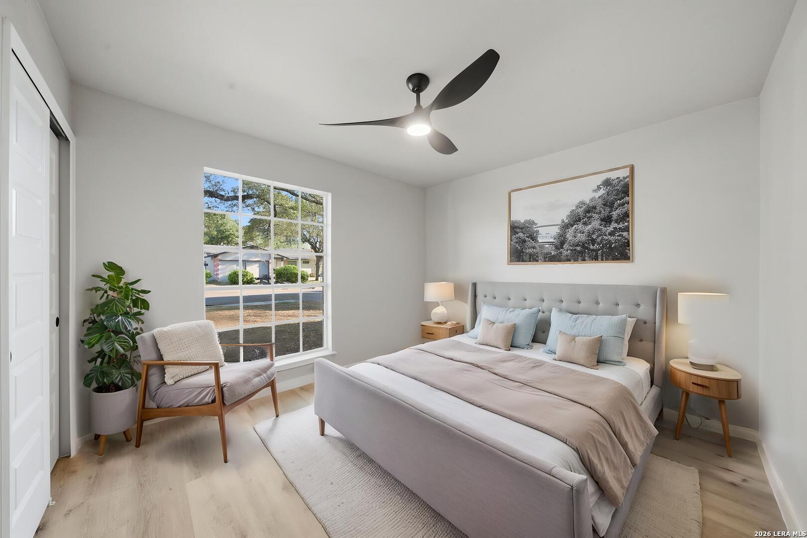 9446 Cliff Way Street San Antonio, TX 78250 - Photo 22 of 24 a bedroom with a large bed and a potted plant