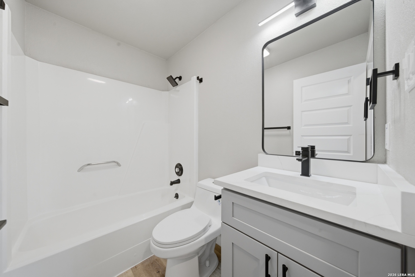 9446 Cliff Way Street San Antonio, TX 78250 - Photo 23 of 24 a bathroom with a sink toilet and mirror