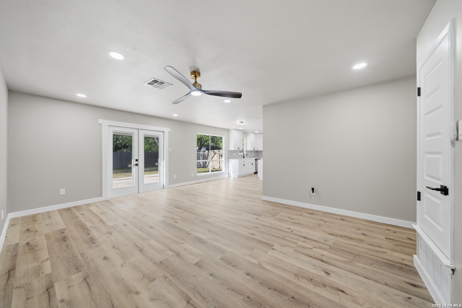 9446 Cliff Way Street San Antonio, TX 78250 - Photo 4 of 24 a view of livingroom with hardwood floor and a ceiling fan