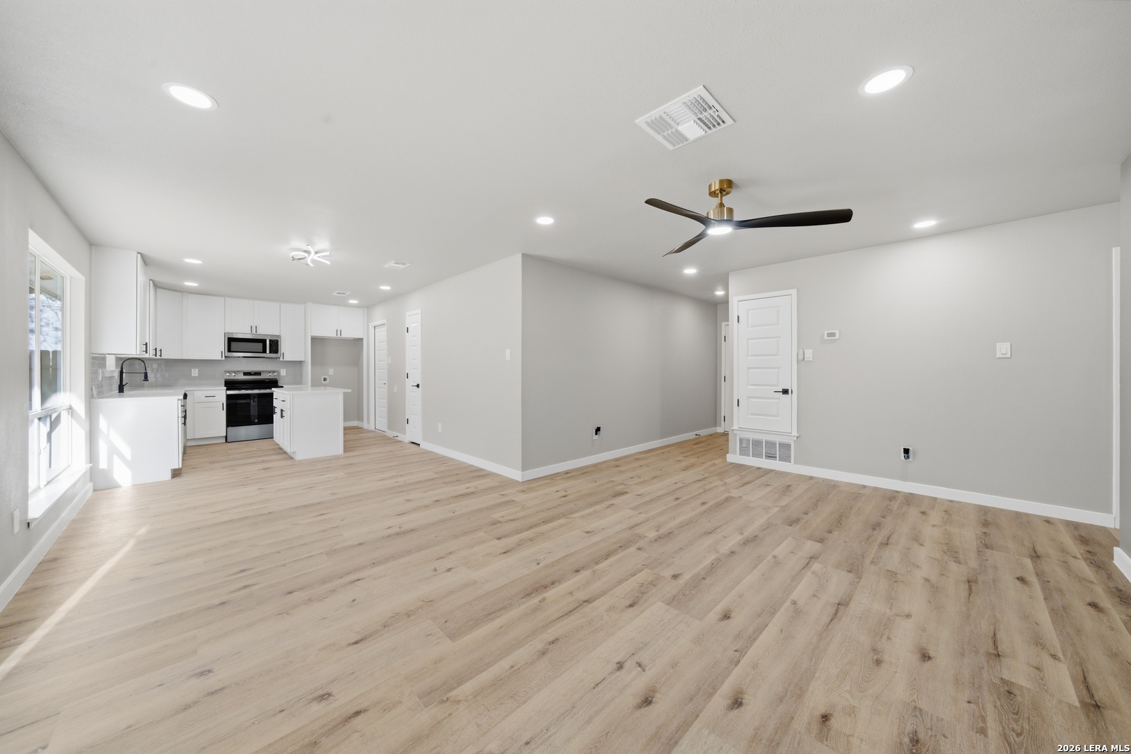 9446 Cliff Way Street San Antonio, TX 78250 - Photo 6 of 24 a view of empty room with wooden floor and window