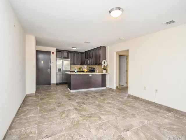 a view of kitchen and refrigerator
