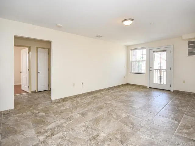 an empty room with windows and closet
