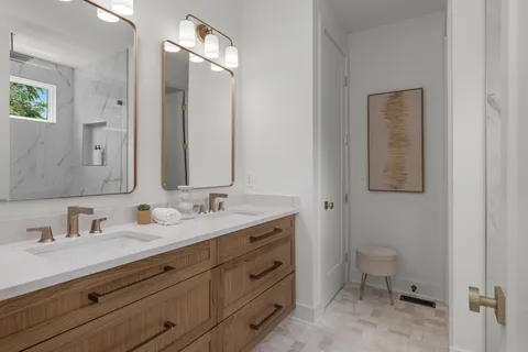 a bathroom with a double vanity sink and a mirror