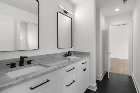 a bathroom with a granite countertop sink and a mirror