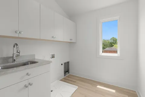 a kitchen with white cabinets and a sink