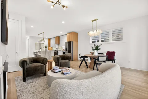 a living room with furniture and a chandelier