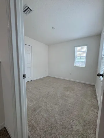 a view of a patio with dining table and chairs