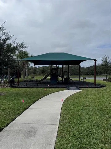 a view of a swimming pool with a yard
