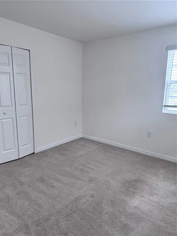 a view of an empty room and a window