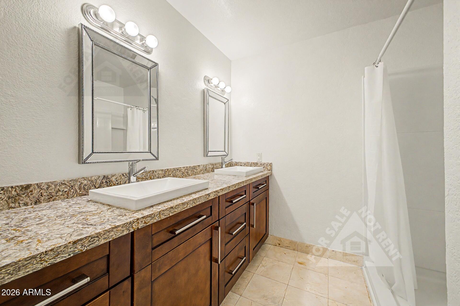 912 East Villa Rita Drive Phoenix, AZ 85022 - Photo 18 of 27 a bathroom with a granite countertop sink and a mirror