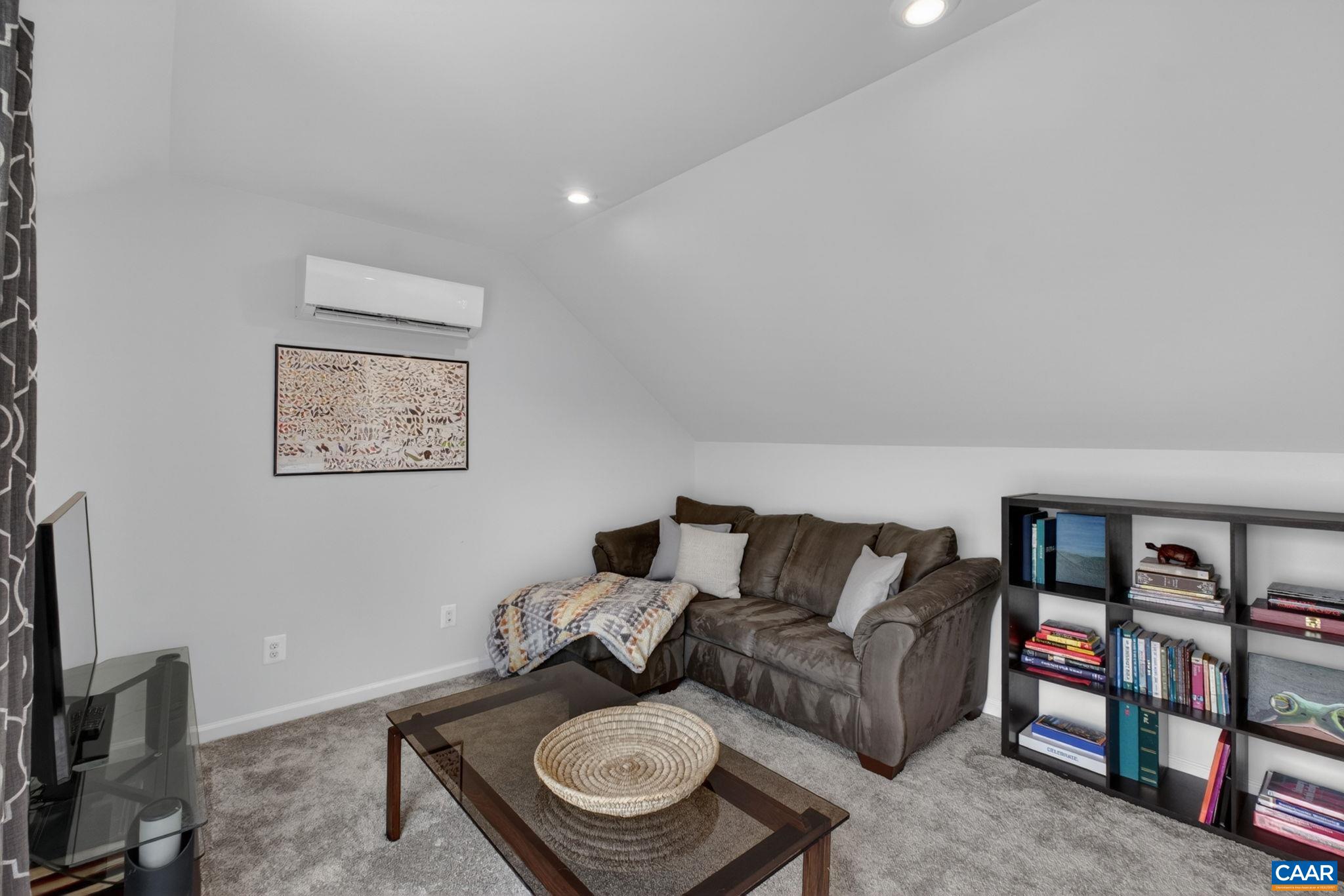 4418 Alston Street Crozet, VA 22932 - Photo 23 of 41 a living room with furniture a rug and a bookshelf