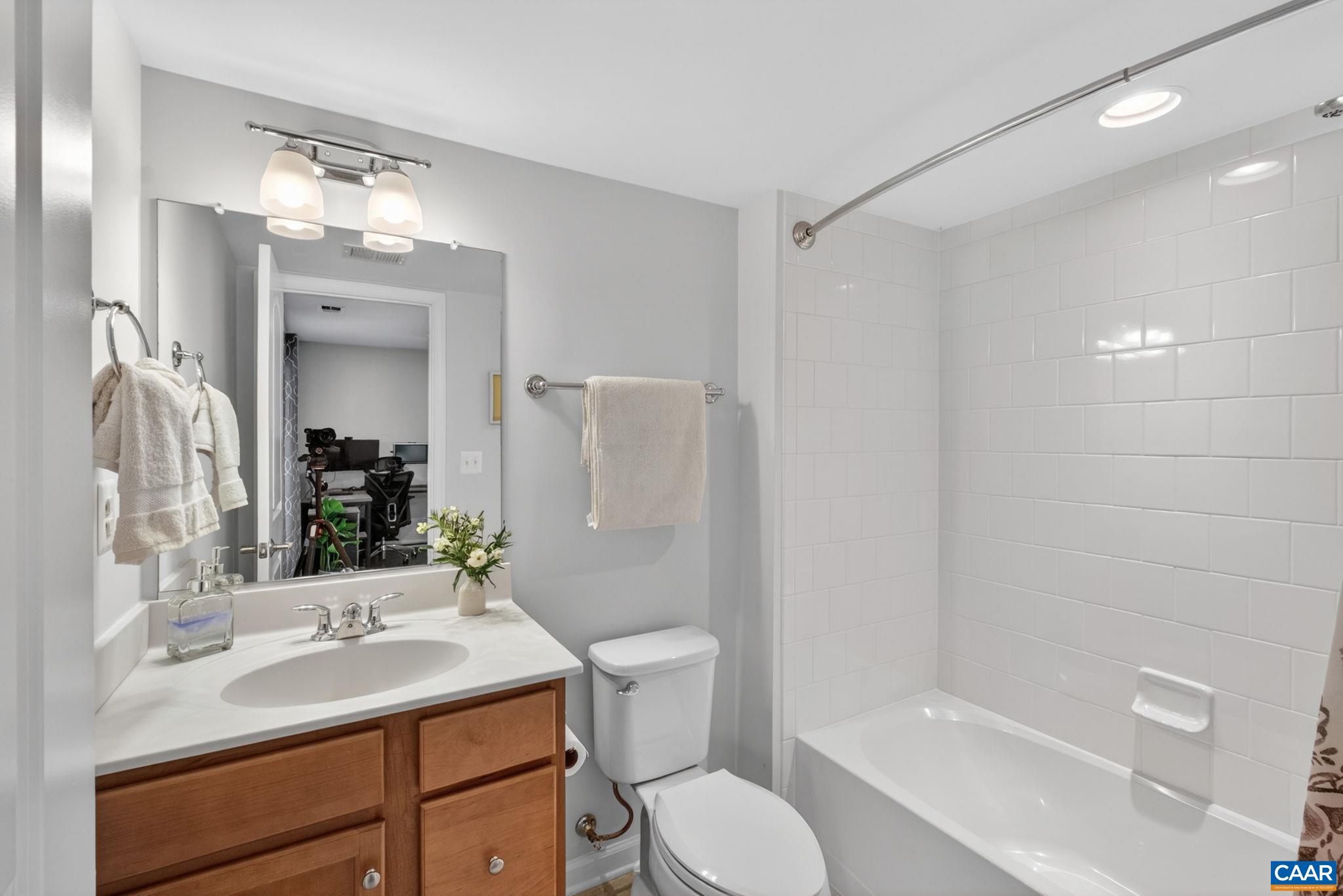 4418 Alston Street Crozet, VA 22932 - Photo 28 of 41 a bathroom with a sink toilet vanity and shower