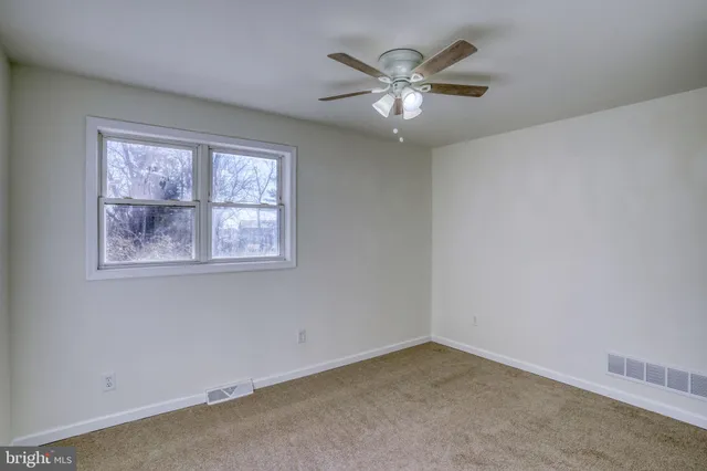 a backyard of a house with barbeque oven table and chairs