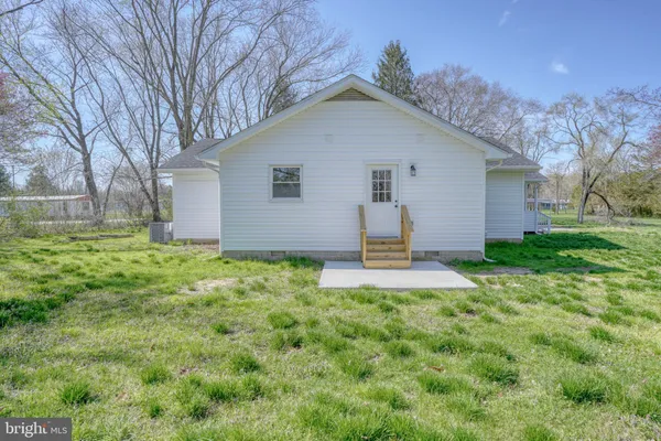 a front view of house with yard and trees