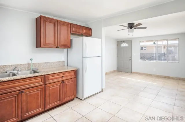 a kitchen with stainless steel appliances granite countertop a refrigerator sink and cabinets
