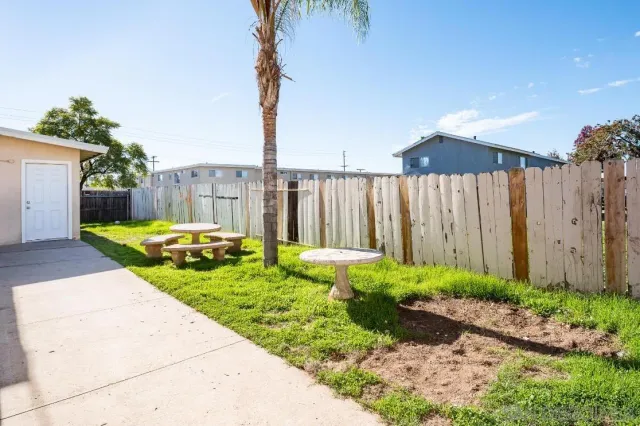 a view of a backyard with potted plants