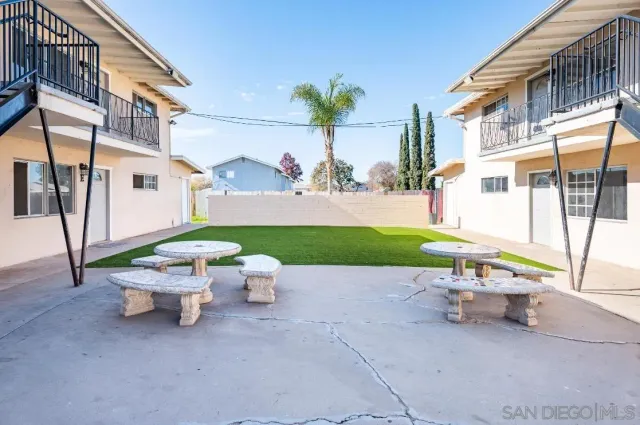 a view of a patio with a table and chairs