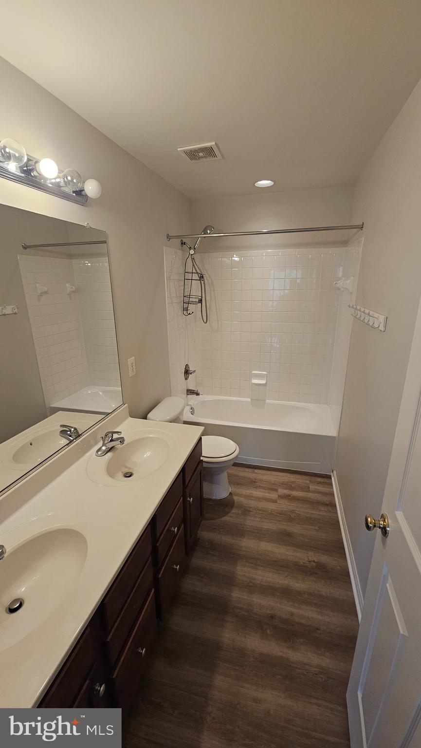 233 MacKenzie Lane Stephenson, VA 22656 - Photo 27 of 54 a bathroom with a sink a toilet a mirror and vanity