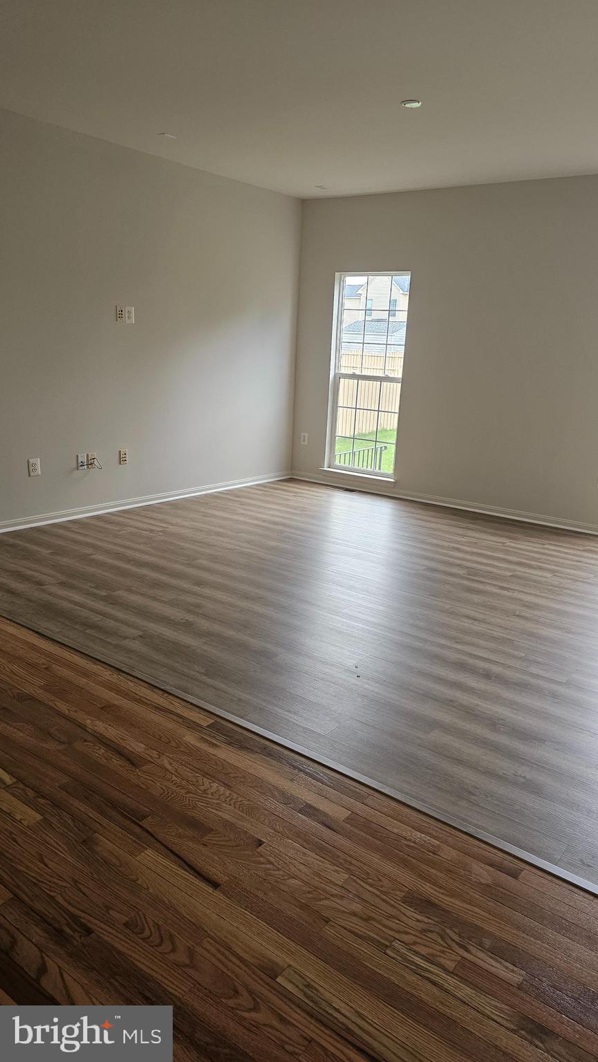233 MacKenzie Lane Stephenson, VA 22656 - Photo 36 of 54 an empty room with wooden floor and windows