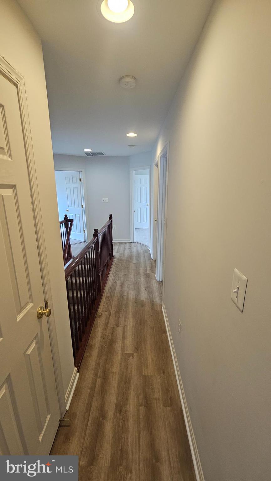 233 MacKenzie Lane Stephenson, VA 22656 - Photo 41 of 54 a view of a hallway with wooden floor and stairs