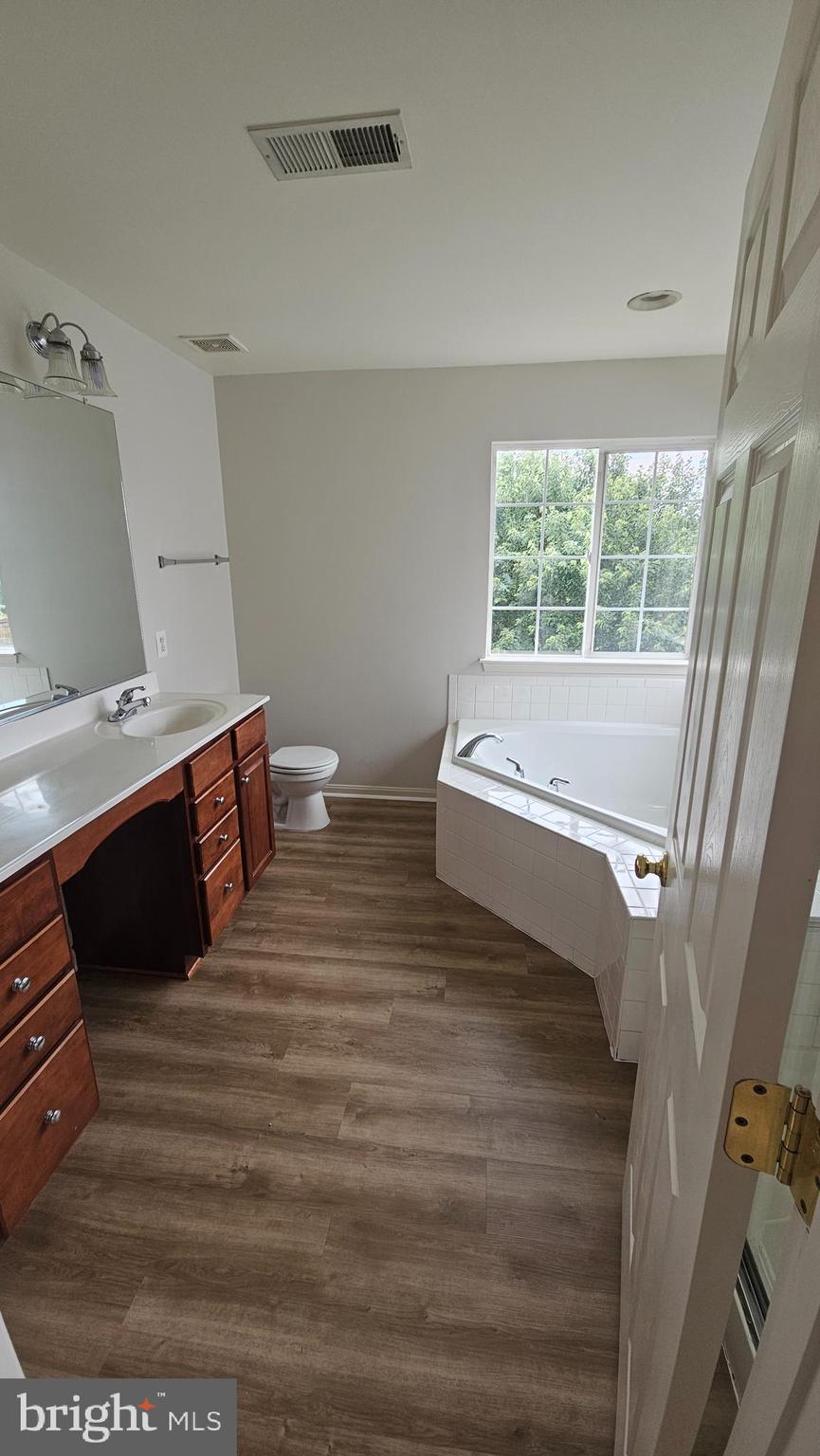 233 MacKenzie Lane Stephenson, VA 22656 - Photo 46 of 54 a spacious bedroom with a bed and a large window