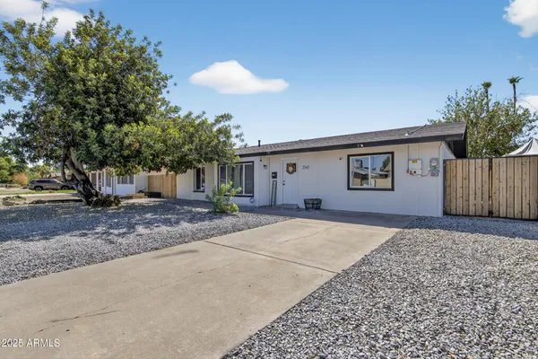 a view of a house with a backyard