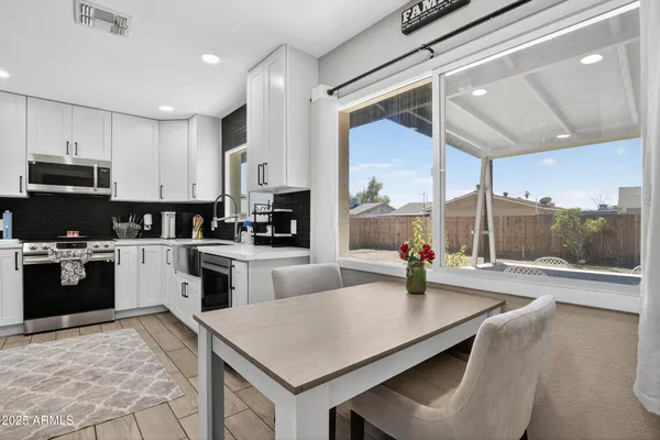a kitchen with stainless steel appliances a stove sink and cabinets