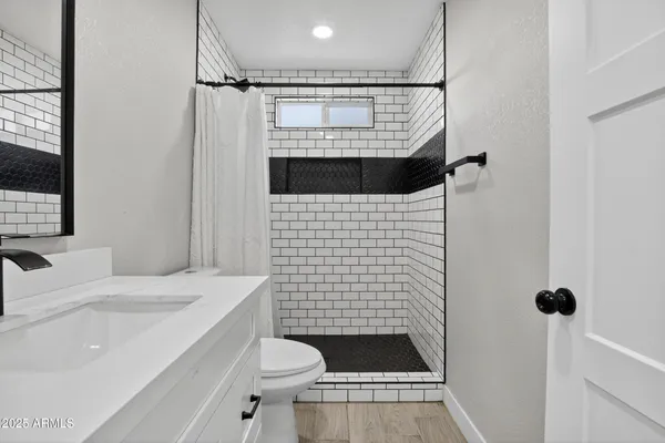 a bathroom with a sink toilet and shower