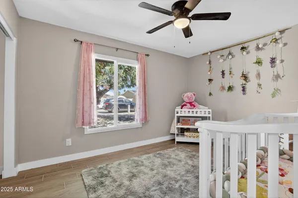 a bedroom with furniture window and wooden floor