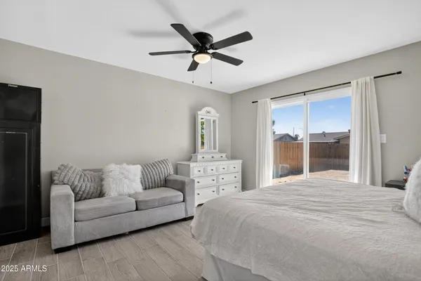 a living room with furniture ceiling fan and a window