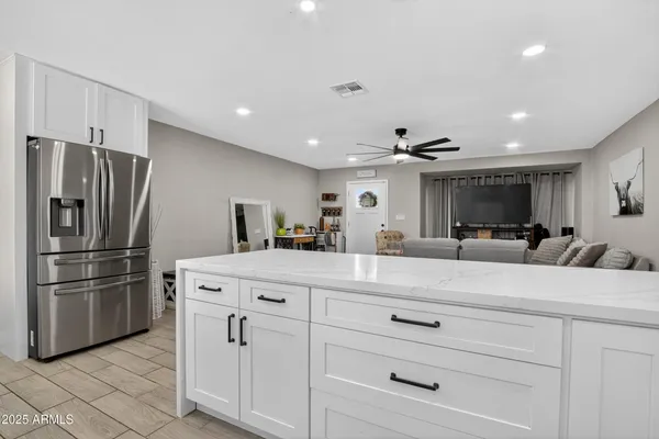 a kitchen with kitchen island a counter top space stainless steel appliances and cabinets