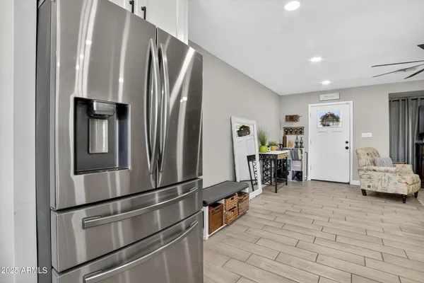 a kitchen with stainless steel appliances a refrigerator and table
