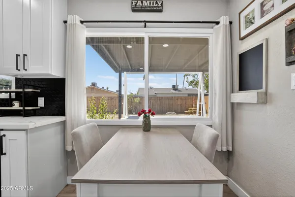 a view of a kitchen with a fridge and window