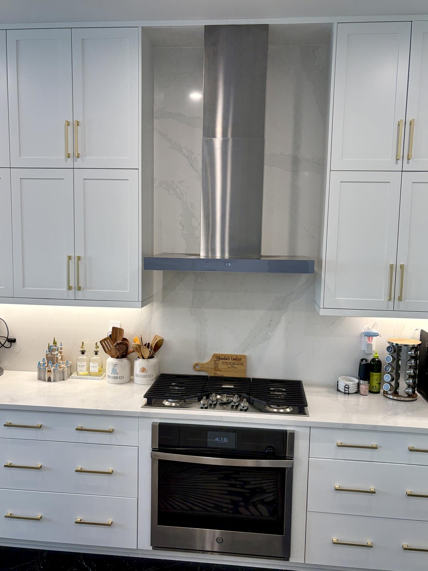 8573 Crystal Downs Avenue Boca Raton, FL 33434 - Photo 17 of 82 a kitchen with granite countertop white cabinets and white appliances