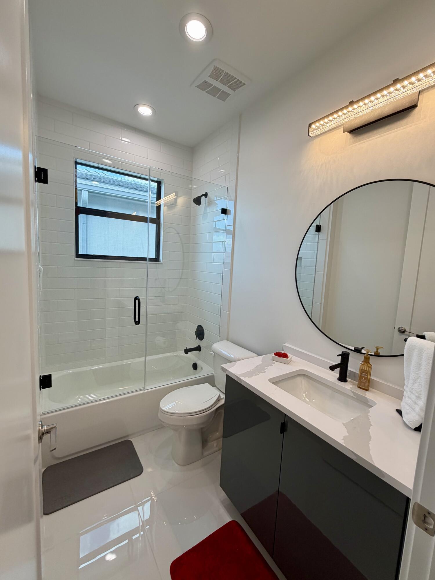 8573 Crystal Downs Avenue Boca Raton, FL 33434 - Photo 41 of 82 a bathroom with a double vanity sink toilet mirror and bathtub