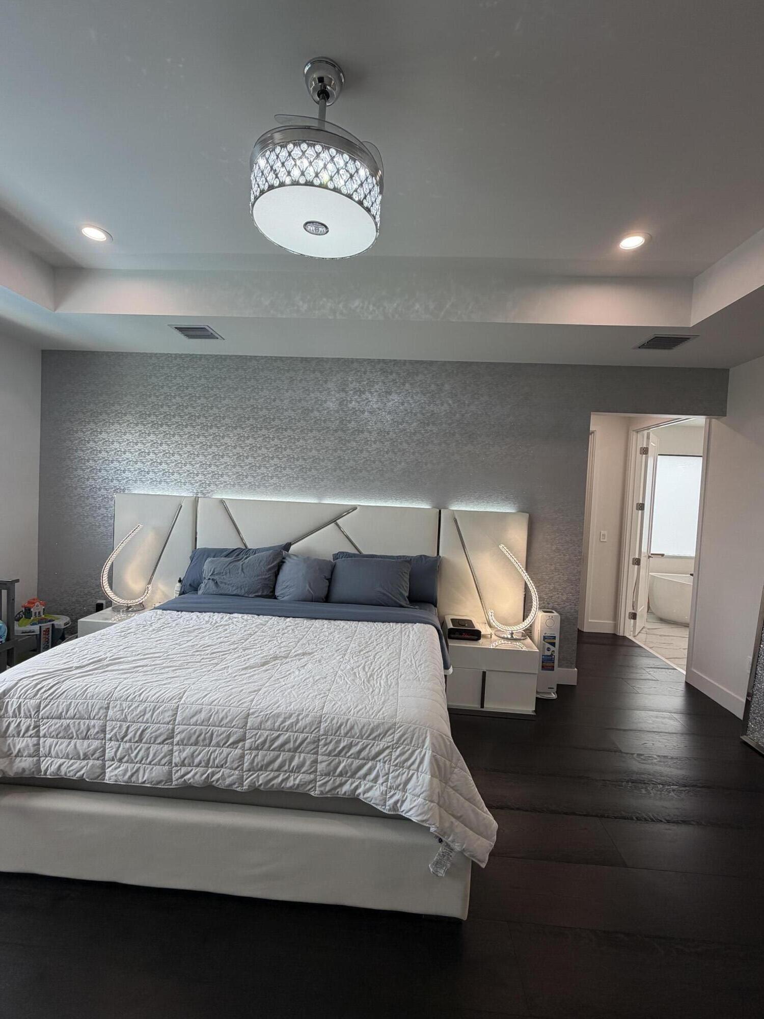 8573 Crystal Downs Avenue Boca Raton, FL 33434 - Photo 45 of 82 a spacious bedroom with a bed and wooden floor