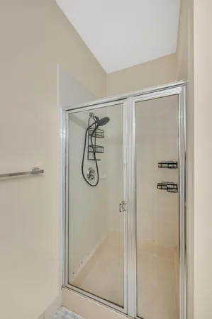 a bathroom with a glass shower door