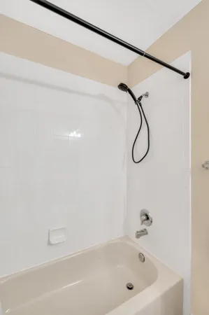 a bathroom with a bath tub with a shower
