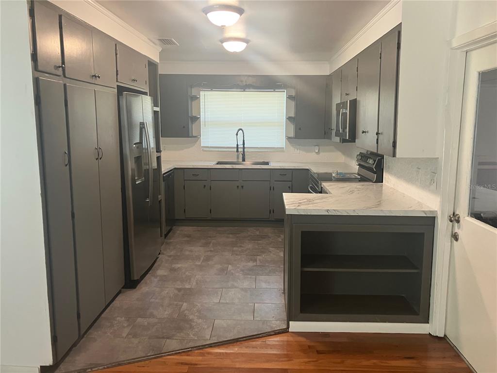 3808 Broad Street Seffner, FL 33584 - Photo 3 of 9 a large kitchen with a sink and a refrigerator