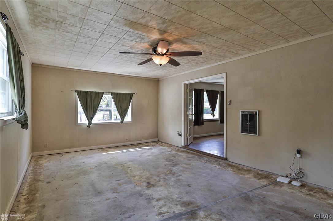 1034 Pine Tree Drive Slatington, PA 18080 - Photo 11 of 46 an empty room with windows and fan