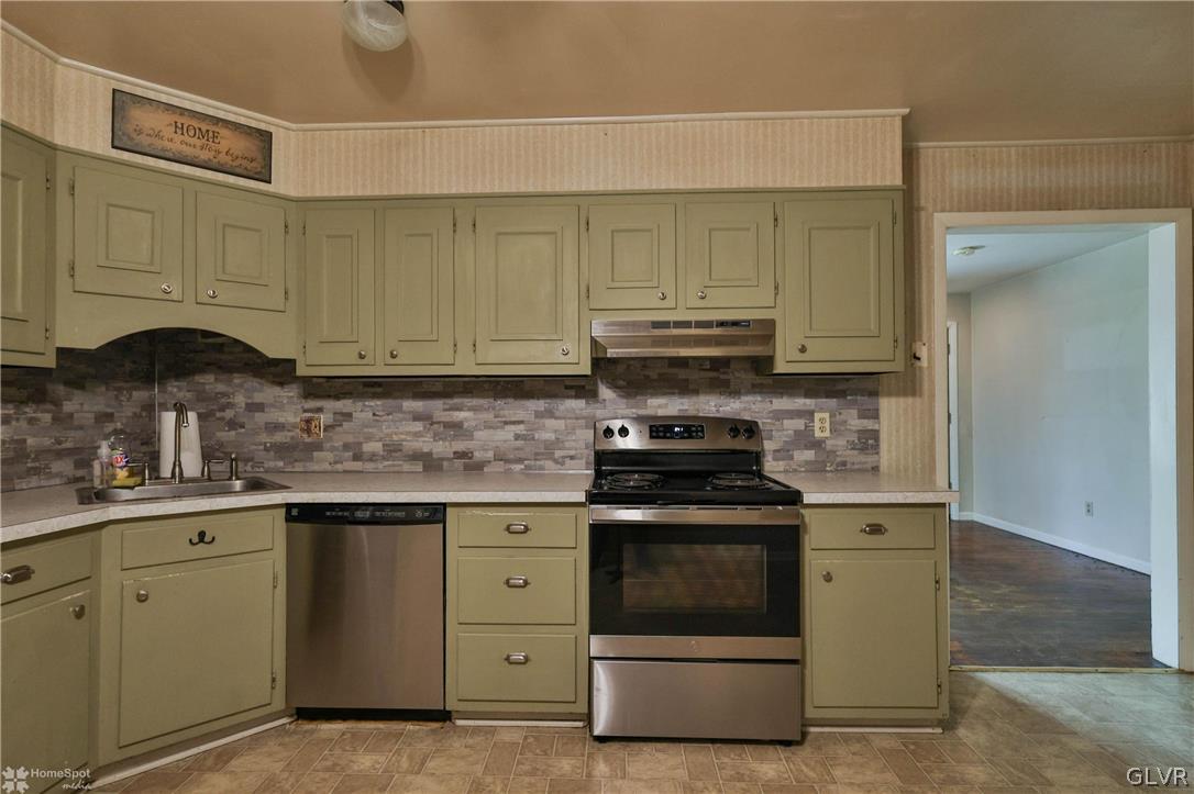 1034 Pine Tree Drive Slatington, PA 18080 - Photo 15 of 46 a kitchen with stainless steel appliances granite countertop a stove a sink and a microwave