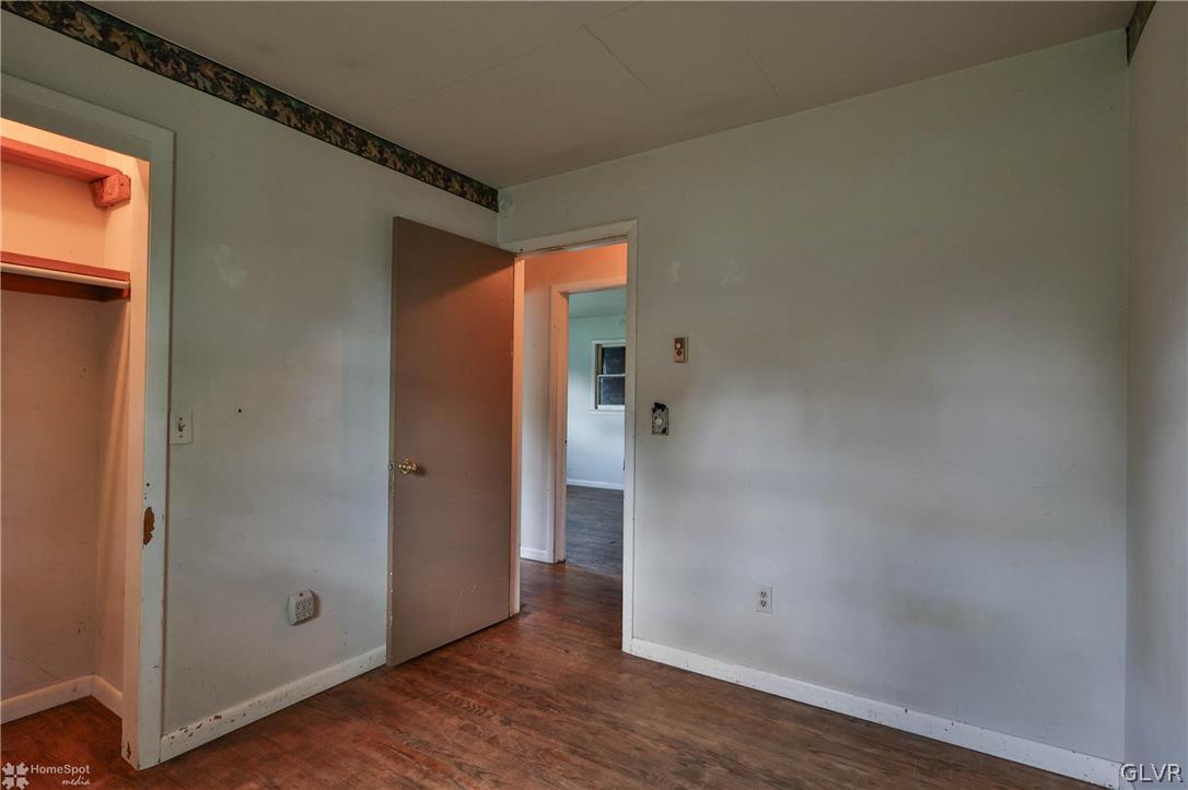 1034 Pine Tree Drive Slatington, PA 18080 - Photo 18 of 46 an empty room with wooden floor and a window