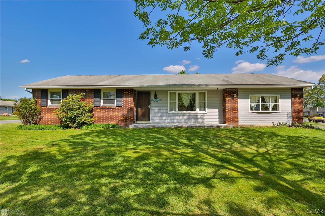 1034 Pine Tree Drive Slatington, PA 18080 - Photo 2 of 46 a front view of a house with a garden